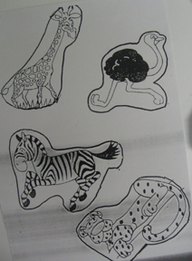 Student work showing animals camouflaged in their surroundings